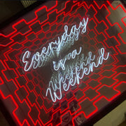 The Maytrix “Everyday Is A Weekend” Infinity Mirror LED Neon Sign Wall Art features white cursive text with a red geometric border, reflected in a mirrored background for an optical illusion tunnel effect.