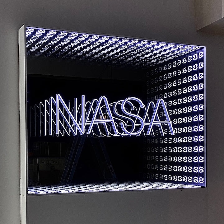 A Custom Logo Infinity Mirror displays a neon NASA sign with a geometric, illuminated pattern.
