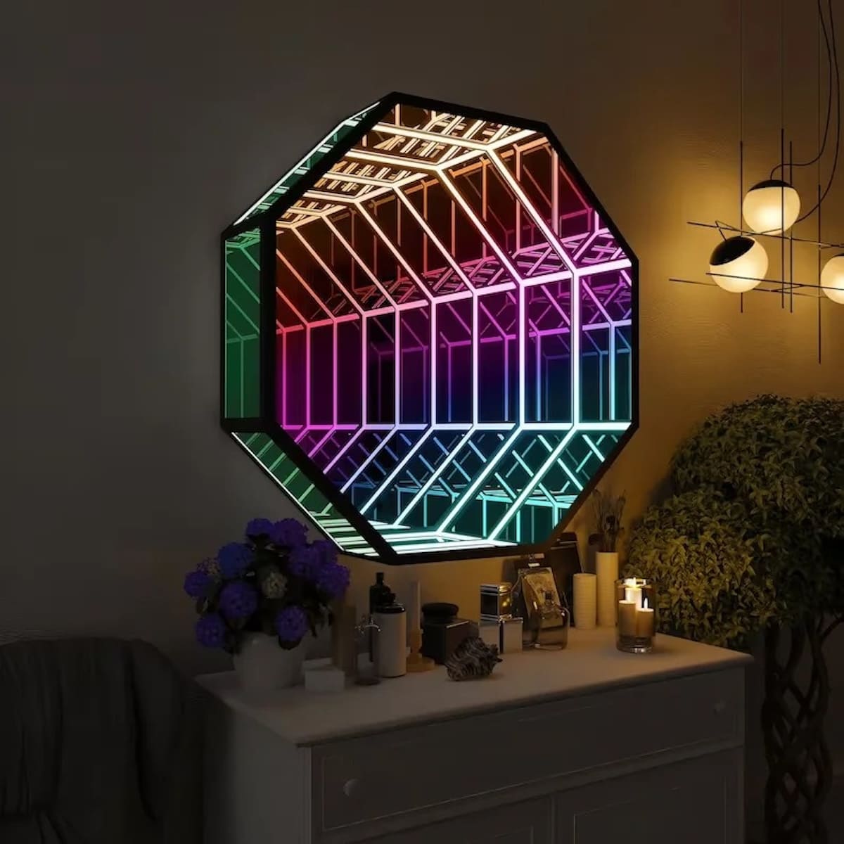 The Octagon Infinity Mirror features colorful LED lights, reflecting a geometric design above a white dresser.