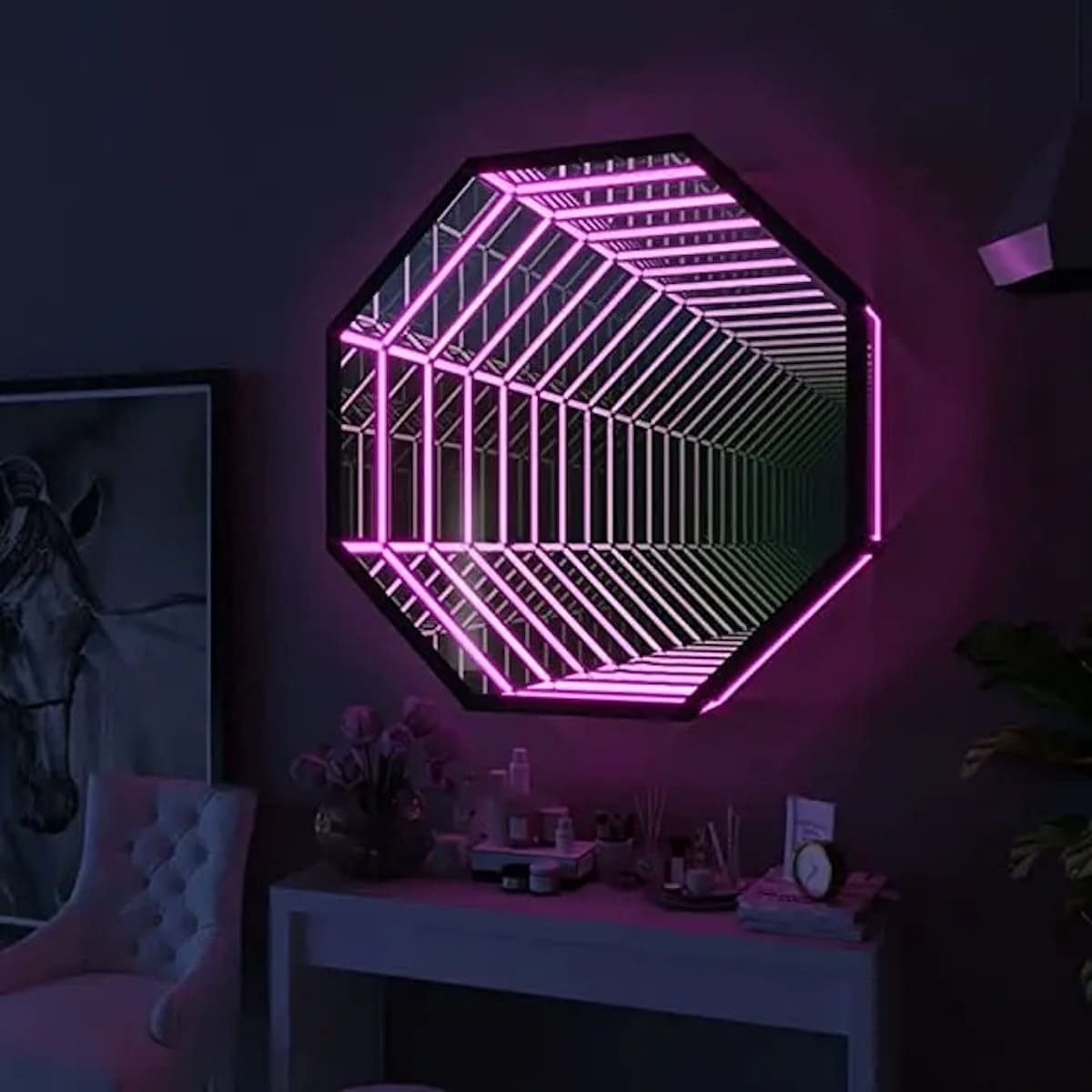 The Octagon Infinity Mirror with pink LEDs creates an endless tunnel effect, ideal modern wall art for above a desk.