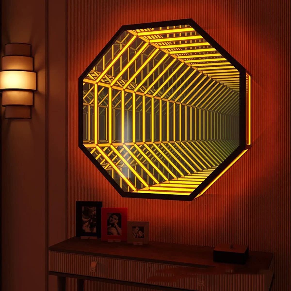The Octagon Infinity Mirror with glowing yellow LEDs adds striking wall decor above a table of framed photos.