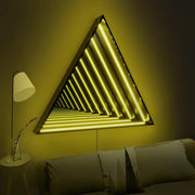 The Maytrix Triangle Infinity Mirror wall light creates a stunning infinity effect above the bed. Combined with a white floor lamp and round side table, it enhances the modern ambiance of this softly lit room.