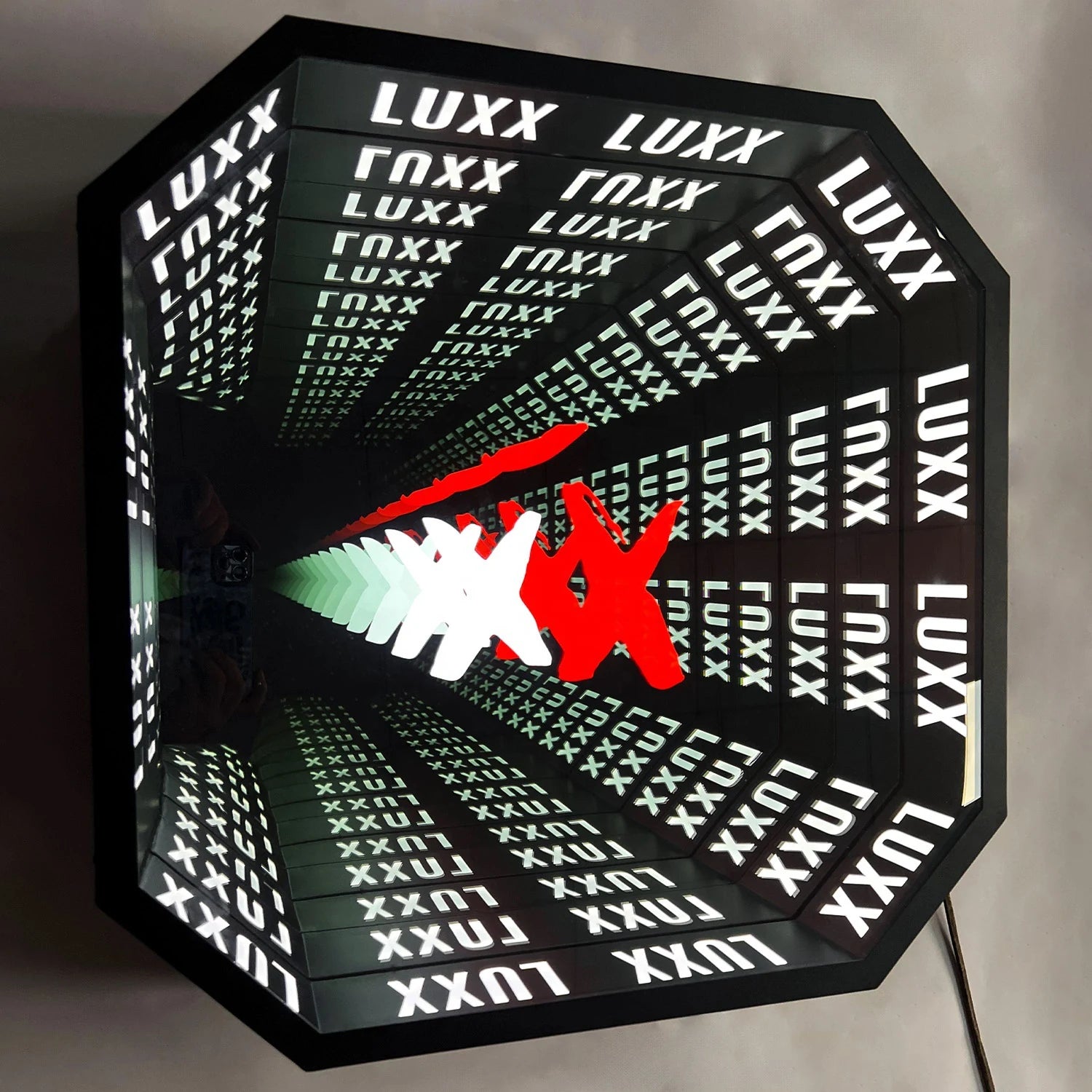 Custom infinity mirror showing detailed artwork and lettering repeated through the optical depth.