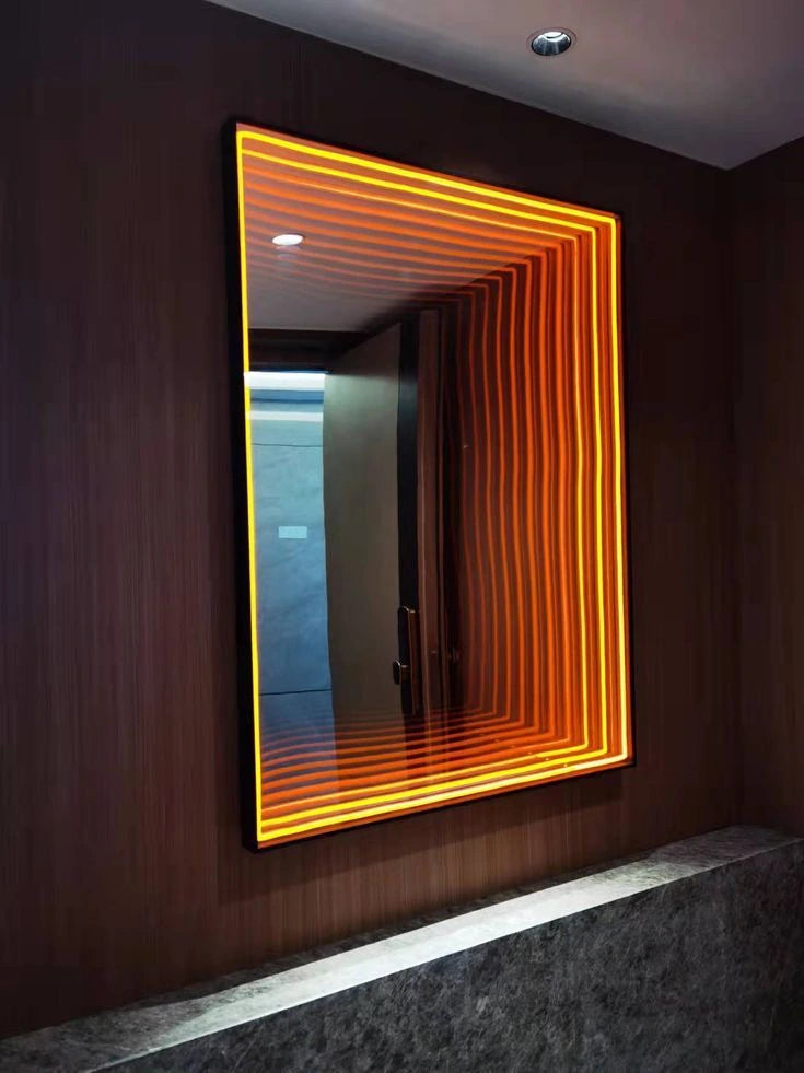 Wall-mounted rectangular infinity mirror with warm orange light repeating into apparent depth.